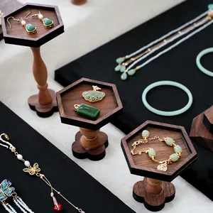 Vintage walnut wood jewelry display set featuring green jadeite necklaces and earrings