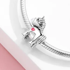 S925 sterling silver unicorn charm with pink enamel heart on a silver snake chain bracelet