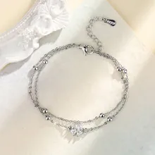 Detailed view of S925 sterling silver dual-layer bracelet with clover zircon pendant