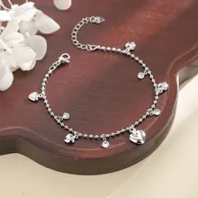 Detail of silver beaded bracelet with heart charms and sparkling round rhinestones