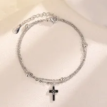 Detail of S925 sterling silver stamp on double-layer chain bracelet with cross charm