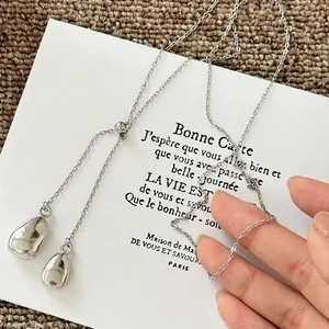 Adjustable silver water drop necklace with Y-shape slider chain on a display card