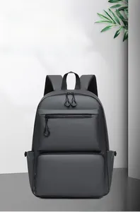 Detail of waterproof leather texture and dual zippered front pockets on the black backpack