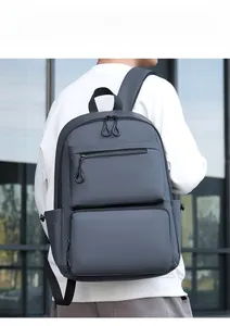 Modern charcoal grey business backpack with padded straps shown from a back view on a model