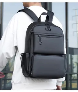 Detailed view of black waterproof business backpack featuring multiple zipper compartments