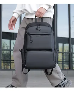 Close-up of waterproof matte black business backpack featuring dual front zipper pockets