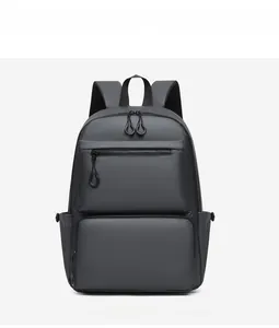 Detail view of water-resistant dark gray backpack showing dual zippers and side pockets
