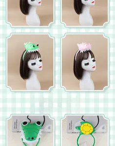Detailed plush animal headbands featuring green crocodile and turtle cartoon designs