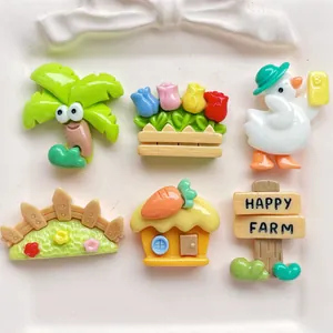 Flat lay of farm-themed DIY resin charms including ducks and trees on a ceramic tray