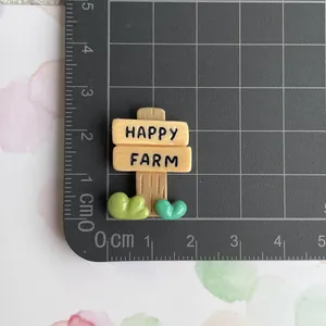 Detailed macro view of a resin Happy Farm sign charm for DIY crafts and accessories