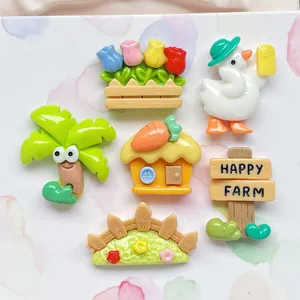 Flat lay of farm theme resin charms including duck, house, flowers and fence for DIY crafts