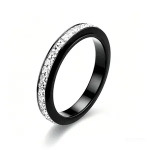 Macro detail of black ceramic band ring with channel set sparkling white square zircons