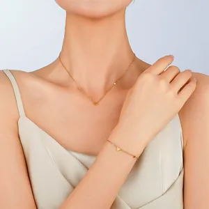 Elegant gold-tone titanium steel necklace and bracelet set with minimalist heart charms