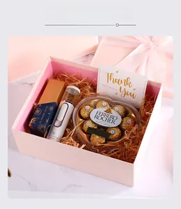 Pink gift box set detail with handheld facial mister, heart chocolates and thank you card