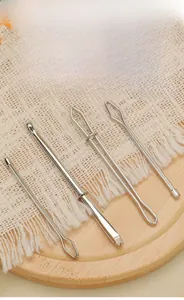 Detail view of 4pcs stainless steel elastic threader set on white woven fabric