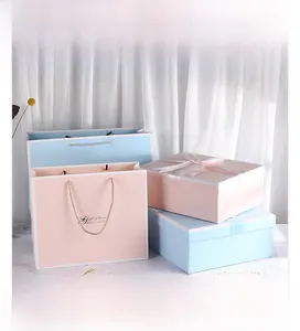 Detail of pink and blue gift boxes with elegant satin bows and matching tote bags