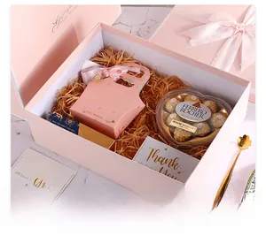 Pink gift box set with interior shred filler, chocolate, satin ribbon and golden spoon