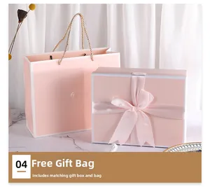 Pink rectangular gift box with matching ribbon bow and premium carrier bag on marble