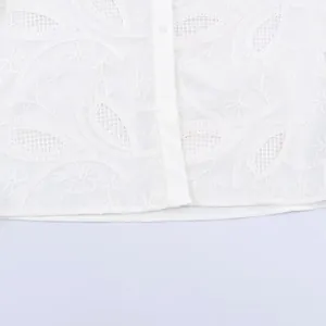 Elegant white embroidered button-down shirt with floral hollow patterns and lapel collar