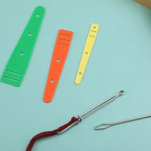 5-piece DIY sewing threader set with plastic guides and metal needles on blue background