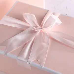 Pink minimalist gift box with a satin ribbon bow for wedding favors and parties