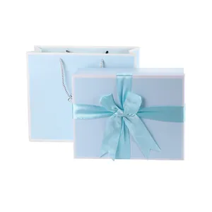 Minimalist light blue gift box and tote bag set with elegant ribbon bow for weddings