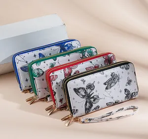 Detail view of long wallets with butterfly and constellation prints and wrist straps