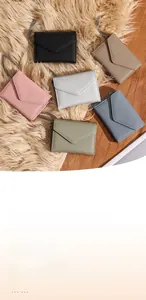 Close-up of slim leather wristlet wallets with litchi texture and chain straps