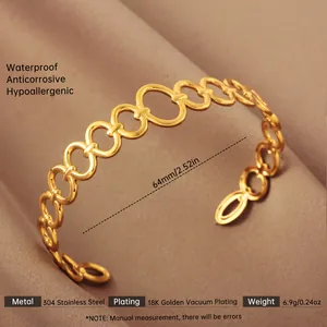 Detail of 18k gold plated stainless steel open bangle with hollow chain link structure