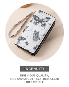 Detail of white leather wallet with butterfly pattern and gold zipper hardware