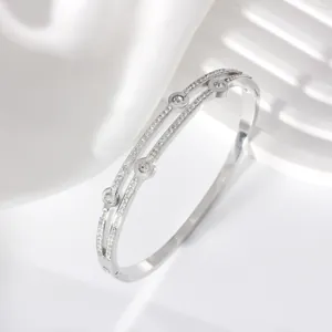 Macro shot of double-row silver stainless steel bracelet with sparkling pavé zircons