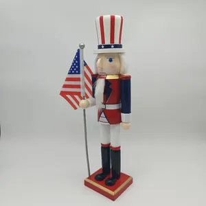 Detail of wooden Uncle Sam nutcracker soldier holding an American flag on white background
