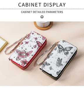 Detail of quilted double zipper long wallet with butterfly print and wrist strap