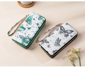 Detail view of double-zipper long wallets with butterfly and constellation prints