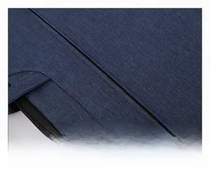 Detailed macro view of durable metal zipper and navy blue fabric texture on laptop bag
