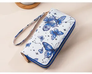 Detail view of double zipper wallet with blue butterfly and constellation print design