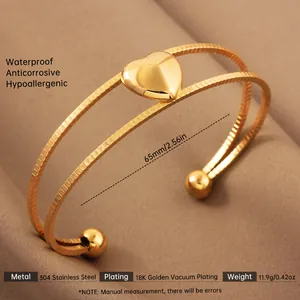 Macro view of 18k gold plated stainless steel heart bangle showing dual band detail