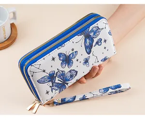 Detail view of double zipper long wallet with blue butterfly galaxy print and gold hardware