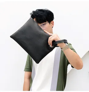 Detail shot of the black lizard embossed leather clutch bag with side handle strap