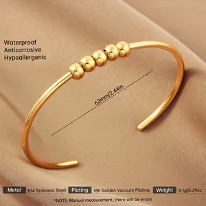 Macro detail of 18k gold plated stainless steel hollow bangle showing size and specs
