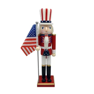 Patriotic wooden nutcracker soldier holding a mini American flag on a red base