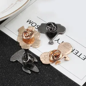 Detailed back view of alloy badges showing gold and black butterfly clutch fasteners