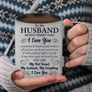Close-up of 11oz ceramic coffee mug with emotional text print and contrasting black handle