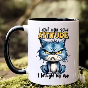 Detail of 11oz ceramic mug with funny cat illustration on mossy outdoor background