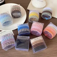 Close-up of high elasticity hair ties in multiple color sets with woven texture
