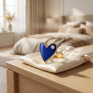 Macro detail of asymmetric blue enamel heart ring with 18K gold plating and zircon stone