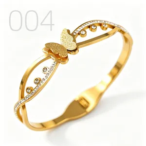 Close-up of gold butterfly cuff bracelet with frosted texture and sparkling zircons