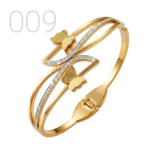 Detailed view of golden butterfly bangle featuring sandblasted finish and zircon pavé