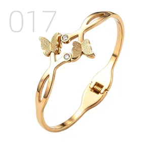 Macro detail of gold-plated butterfly bracelet with matte finish and zircons