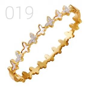 Detail of gold stainless steel butterfly bracelet with mother of pearl and zircons